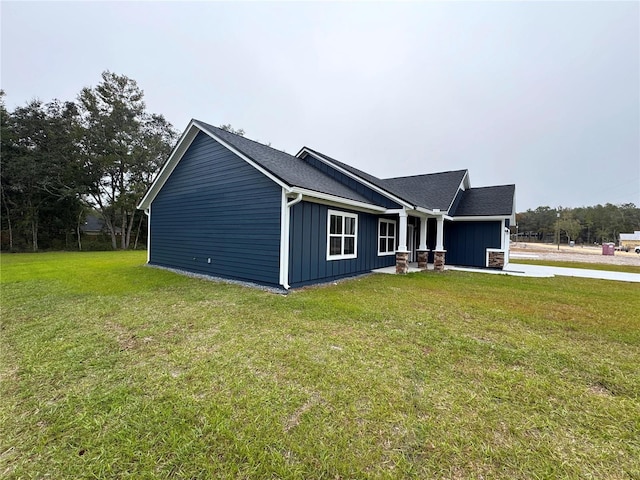 view of side of home with a yard