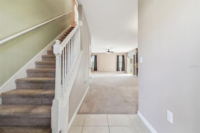 stairs with carpet flooring and ceiling fan