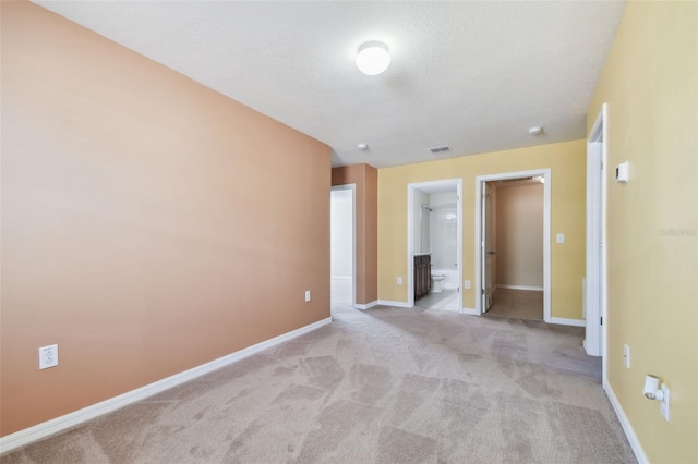 carpeted spare room with a textured ceiling