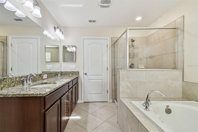 bathroom featuring plus walk in shower, vanity, and tile patterned floors