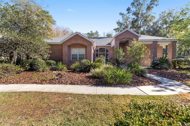 ranch-style home with a front lawn