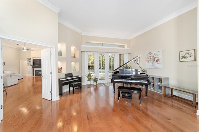 miscellaneous room featuring french doors, light hardwood / wood-style flooring, ceiling fan, and crown molding