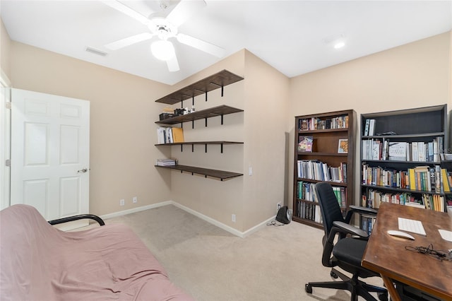 carpeted office featuring ceiling fan