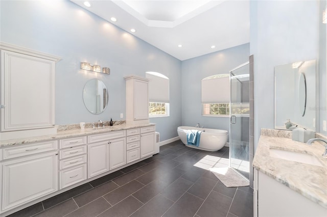 bathroom featuring tile patterned flooring, vanity, and separate shower and tub