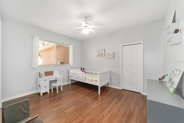 bedroom with dark hardwood / wood-style flooring, a closet, and ceiling fan