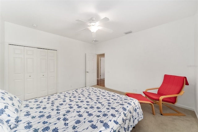 bedroom featuring ceiling fan, a closet, and carpet