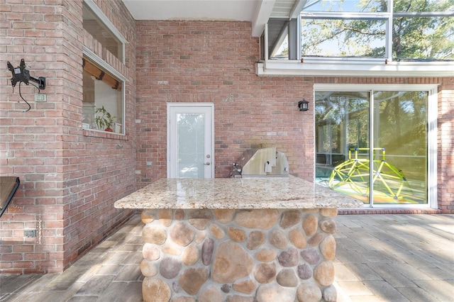 view of patio featuring an outdoor kitchen and a bar