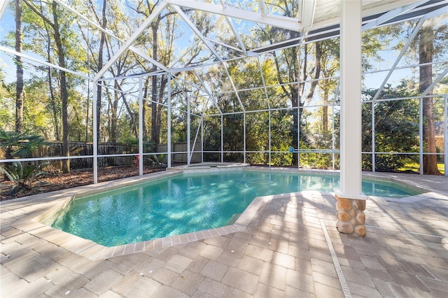 view of swimming pool with a patio area and a lanai