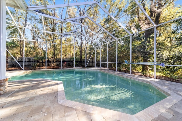 view of pool featuring a patio and glass enclosure