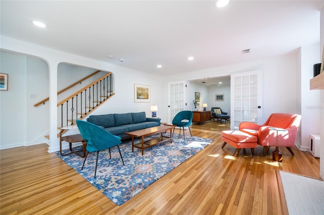 living room featuring french doors and hardwood / wood-style flooring