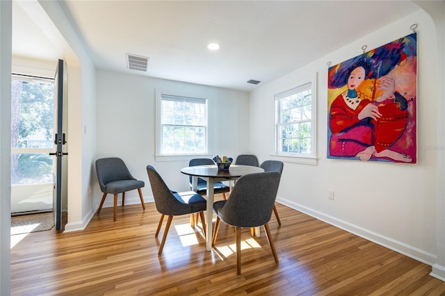 dining area featuring hardwood / wood-style floors and plenty of natural light