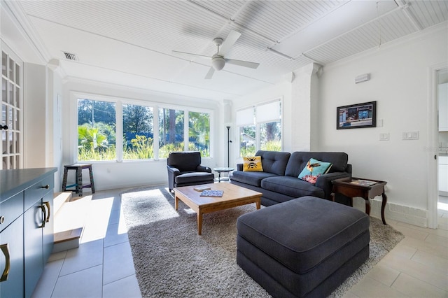 living room with tile patterned flooring, ceiling fan, and crown molding