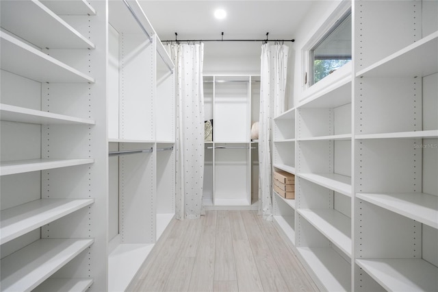 spacious closet featuring light hardwood / wood-style floors