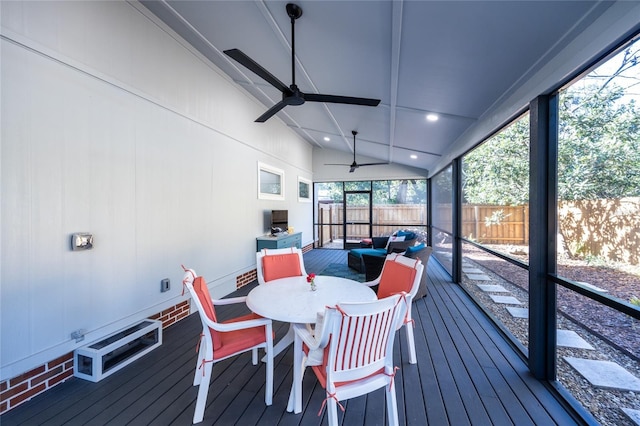 sunroom / solarium with ceiling fan and lofted ceiling