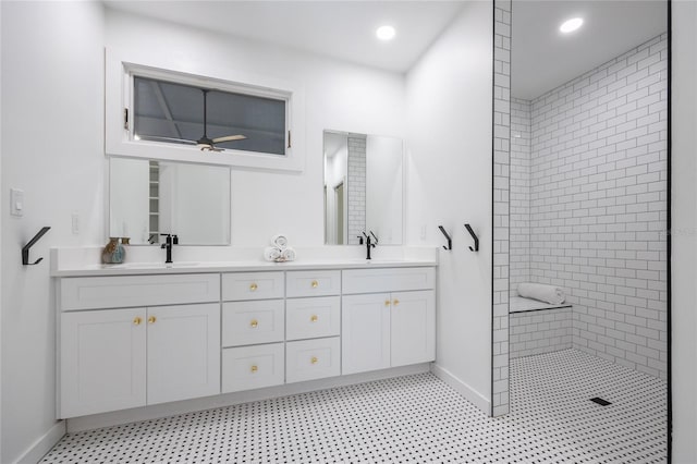 bathroom featuring ceiling fan, vanity, and tiled shower