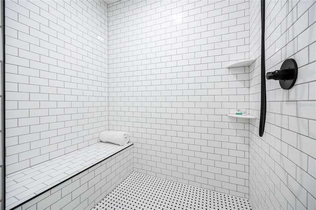 bathroom with a tile shower