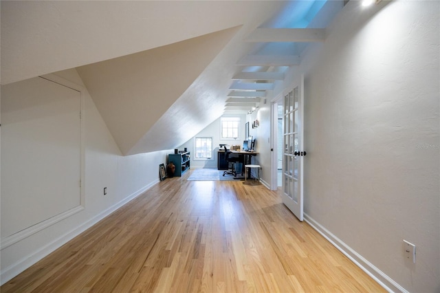 additional living space featuring light hardwood / wood-style floors and lofted ceiling