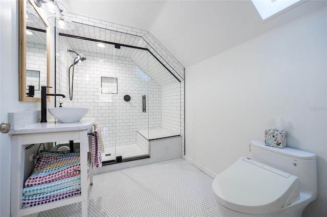 bathroom with tile patterned floors, lofted ceiling with skylight, sink, toilet, and a shower with shower door