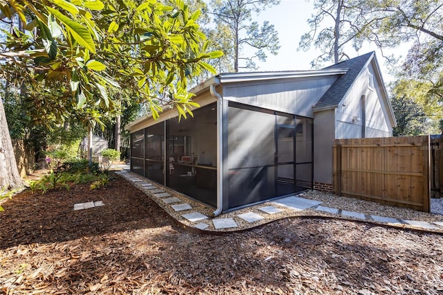 view of outdoor structure featuring a sunroom