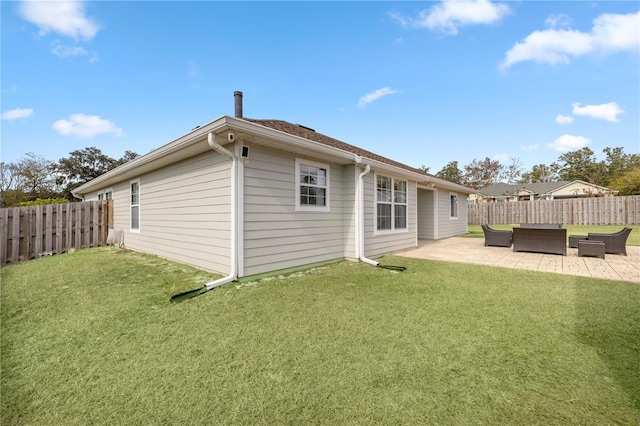 rear view of property featuring an outdoor hangout area, a patio area, and a lawn