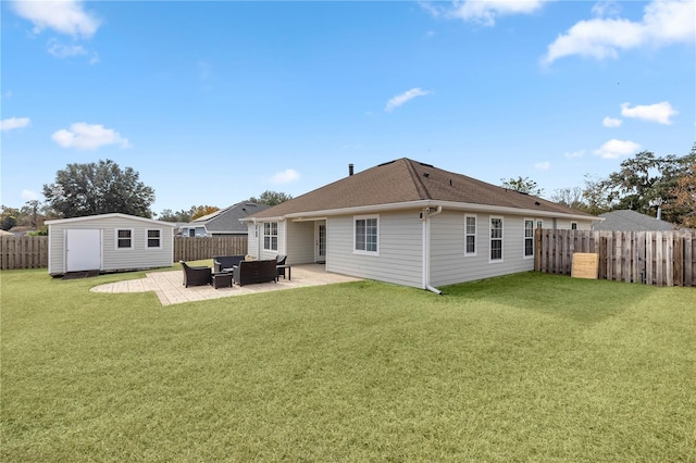 back of house with a patio area, outdoor lounge area, a yard, and a shed