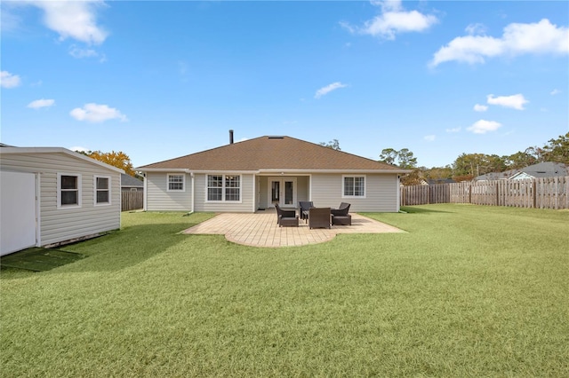 back of property featuring a yard and a patio