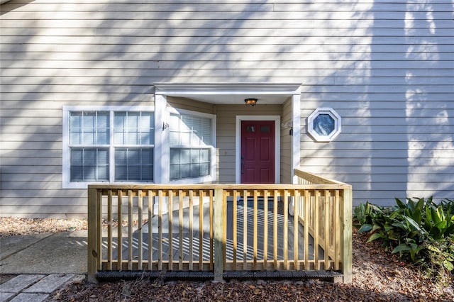 view of exterior entry with a deck