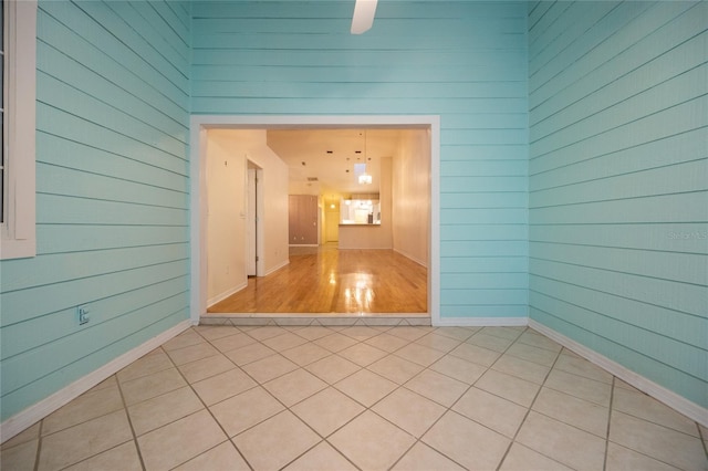 tiled spare room with wooden walls