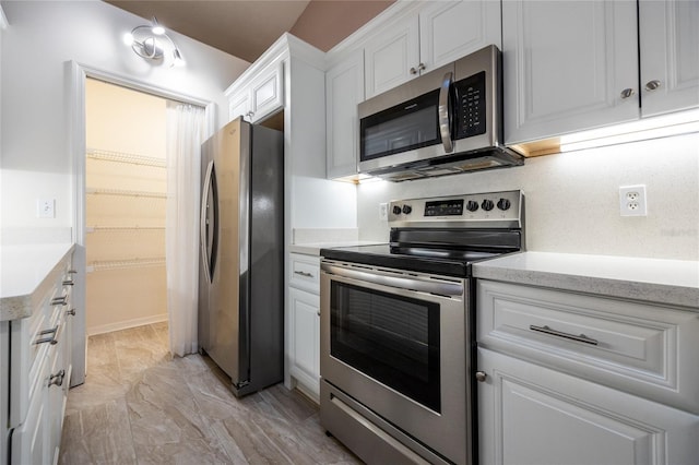 kitchen with white cabinetry and stainless steel appliances