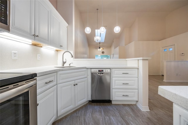 kitchen with pendant lighting, dishwasher, white cabinetry, and sink