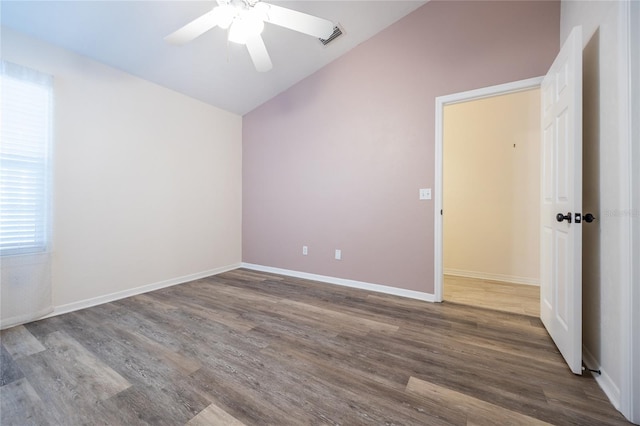 unfurnished room featuring ceiling fan, wood-type flooring, and vaulted ceiling