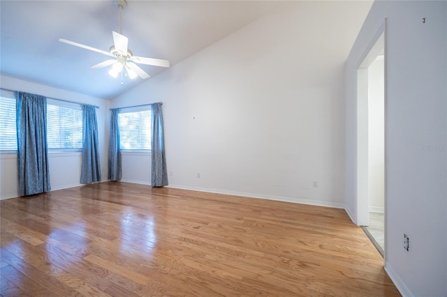 empty room featuring ceiling fan, light hardwood / wood-style floors, and vaulted ceiling