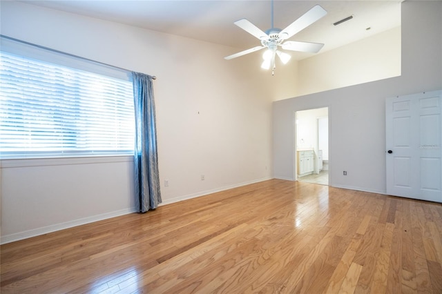 spare room featuring ceiling fan, vaulted ceiling, and light hardwood / wood-style flooring