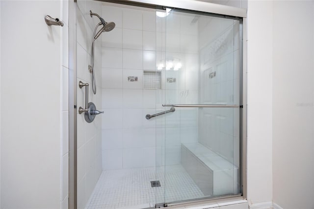 bathroom with a shower with door