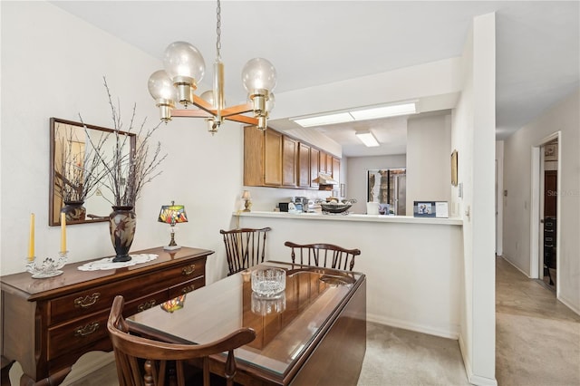 dining space with a chandelier and light colored carpet