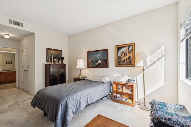 carpeted bedroom featuring sink and connected bathroom