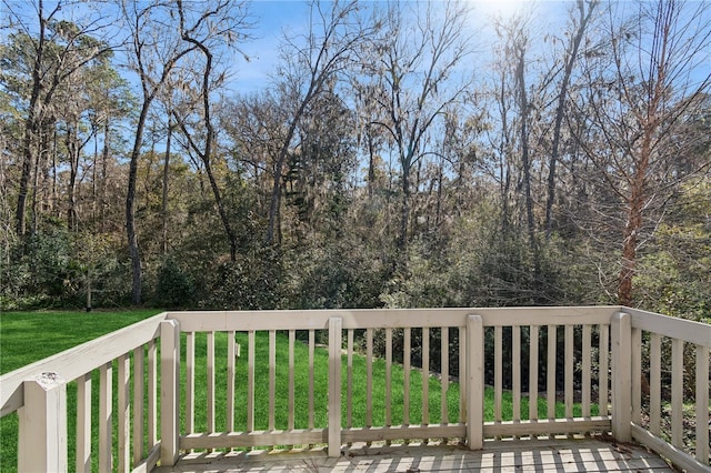 wooden terrace featuring a lawn