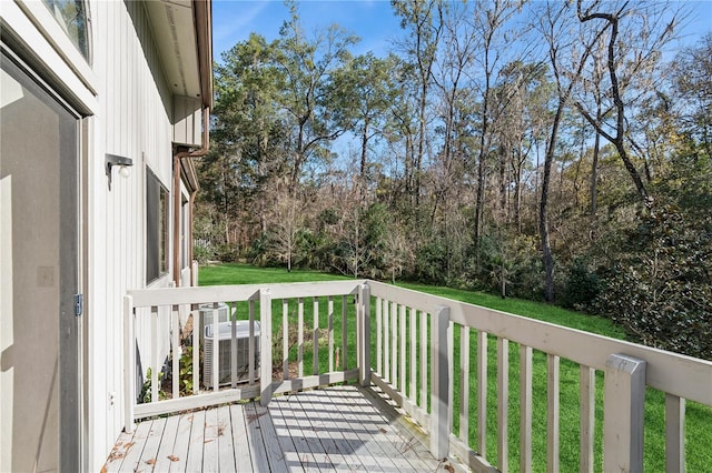 wooden terrace with a lawn and central AC unit