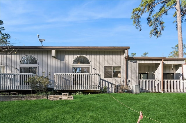 back of house featuring a yard and a deck