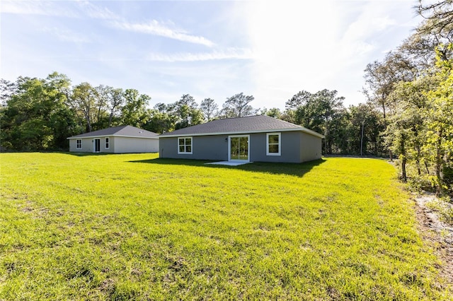 back of property featuring a lawn