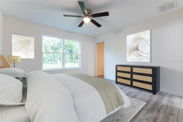 bedroom with hardwood / wood-style floors and ceiling fan