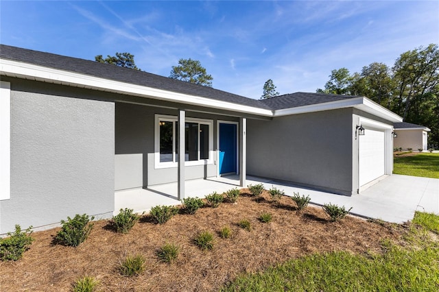 back of property with a garage