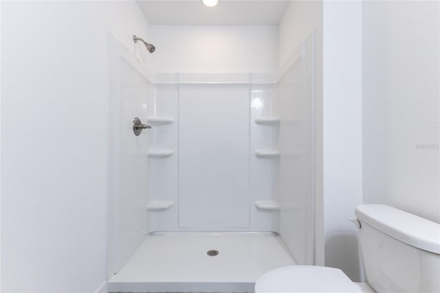 bathroom with toilet and walk in shower