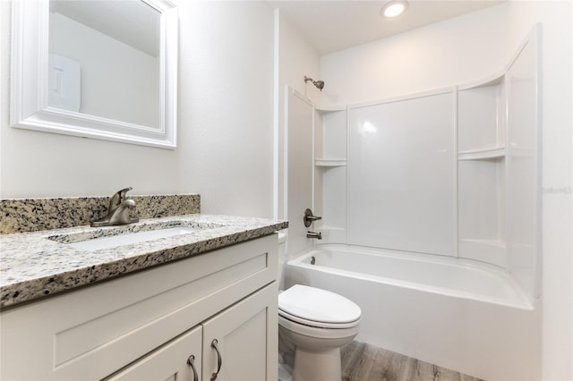 full bathroom featuring hardwood / wood-style flooring, toilet, vanity, and  shower combination