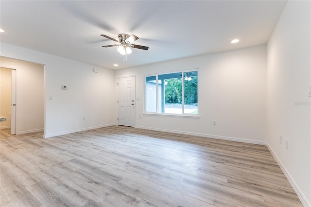 unfurnished room with ceiling fan and light hardwood / wood-style floors