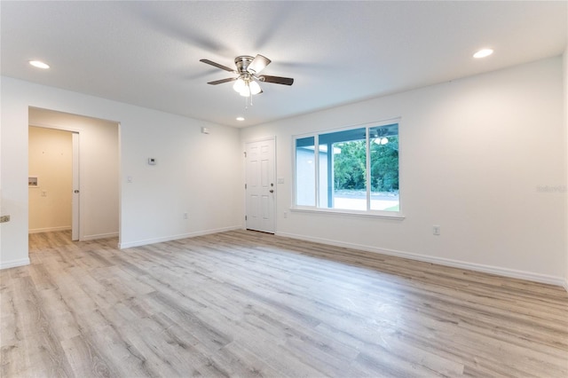 empty room with light hardwood / wood-style flooring and ceiling fan