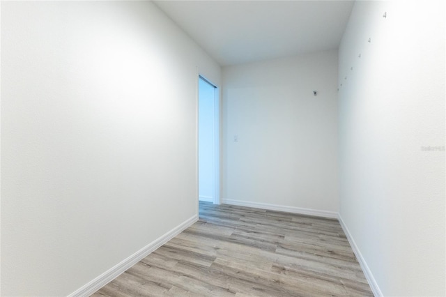 empty room with light hardwood / wood-style flooring