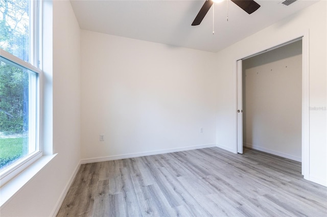 unfurnished bedroom with light wood-type flooring, a closet, and ceiling fan