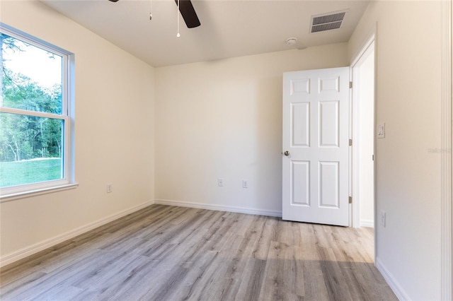 unfurnished room with ceiling fan and light wood-type flooring