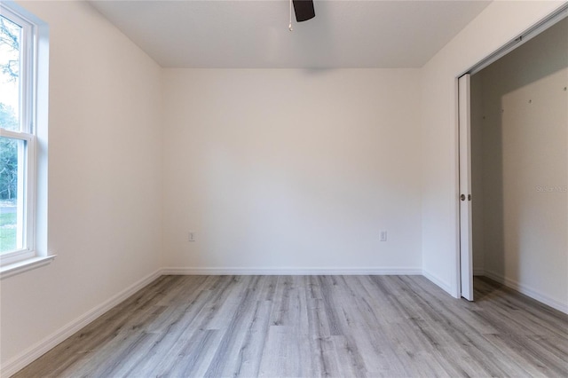 empty room with light hardwood / wood-style floors and a wealth of natural light